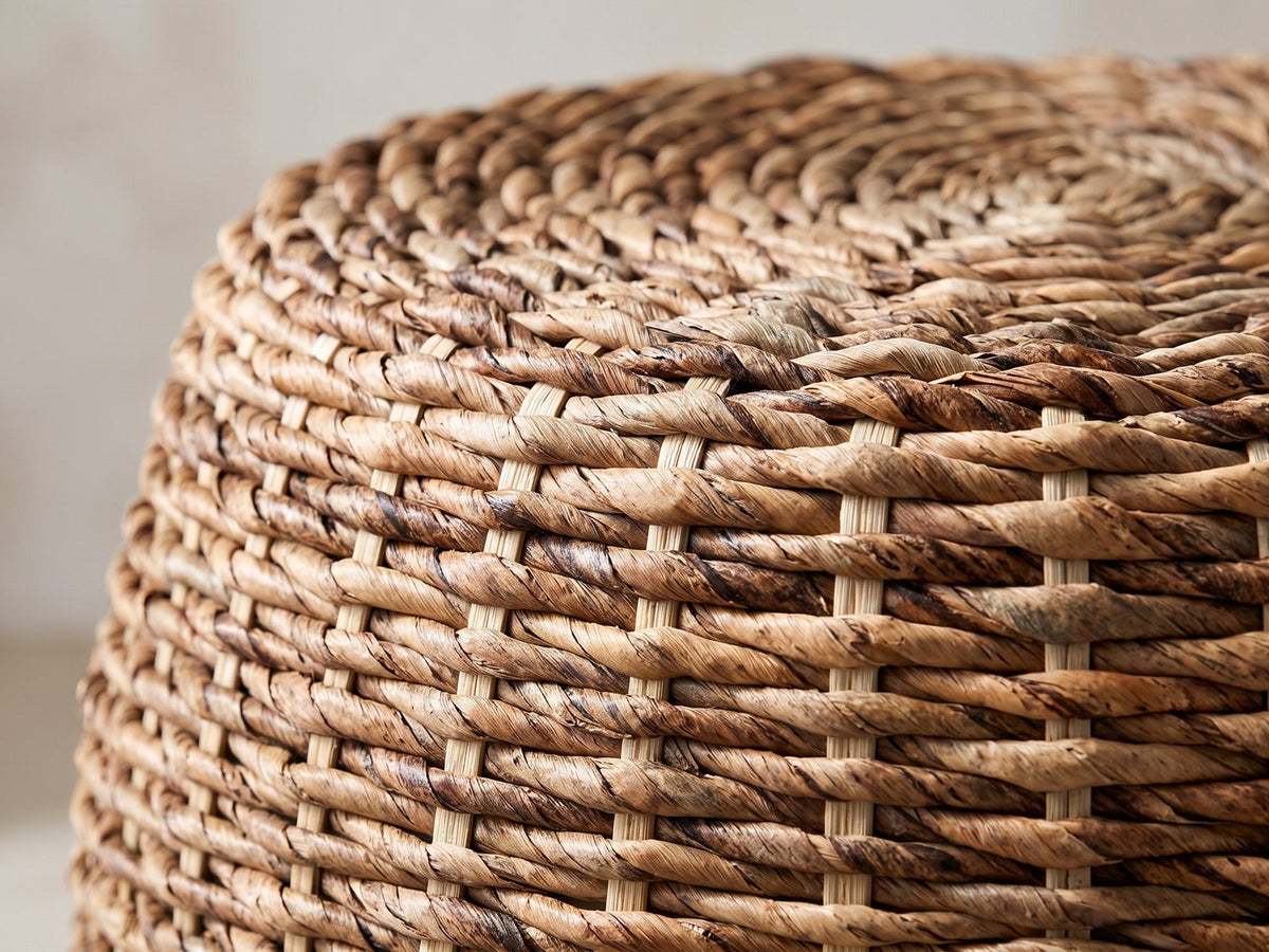 Close-up of the Parabita Woven Natural Fiber Barrel Side Table: the coiled top rolling over into the woven side