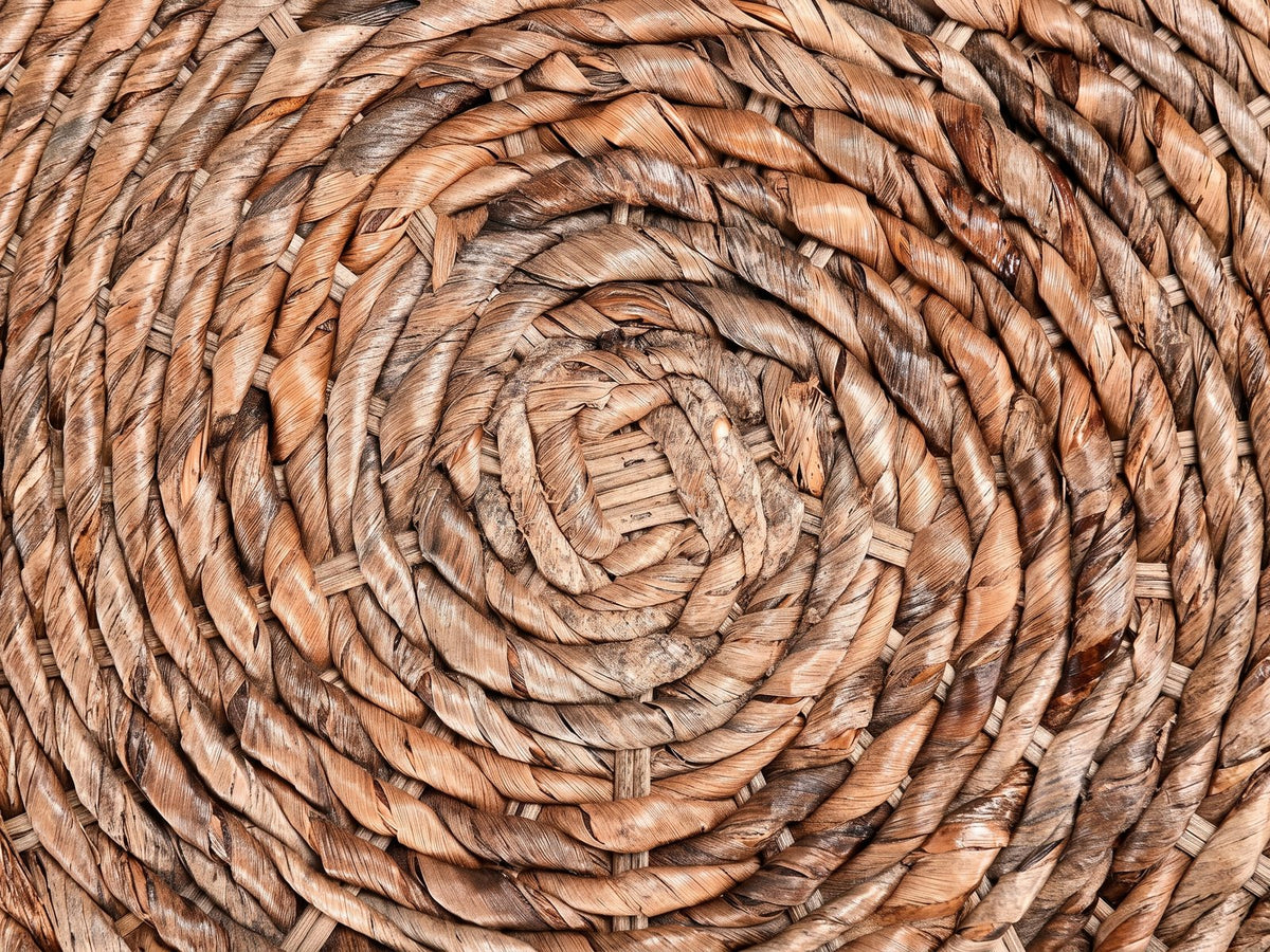 Close-up of the Parabita Woven Natural Fiber Barrel Side Table: the spiral of twisted natural fiber on the top