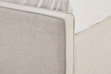 Close-up of the Penne footboard corner in ivory canvas, with the thin self-welt along the top edge and down the corner