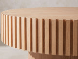 Close-up of the Pesaro Ash Veneer Fluted Pedestal Coffee Table: the ring of ash slats under the notched rim of the top