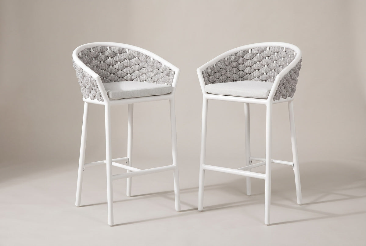 The two Petralia counter stools with white aluminum frames, grey rope barrel backs and pale grey cushions, three-quarter view on a light studio backdrop