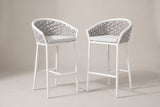 The two Petralia counter stools with white aluminum frames, grey rope barrel backs and pale grey cushions, three-quarter view on a light studio backdrop