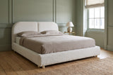 Pietrabbondante bed against a muted sage green panelled wall in a Charleston townhouse bedroom
