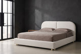 Pietrabbondante ivory boucle bed against a charcoal limewash wall in a Chicago loft, a tall black steel window at the left
