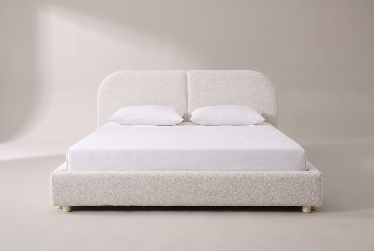 Pietrabbondante bed in ivory boucle with a white mattress and pillows (not included), front view