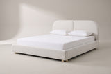 The Pietrabbondante bed in ivory boucle with a white mattress and pillows (not included), three-quarter view on a light studio backdrop
