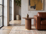 Pietrapertosa Walnut Pedestal Side Table beside a cognac leather armchair in an industrial loft