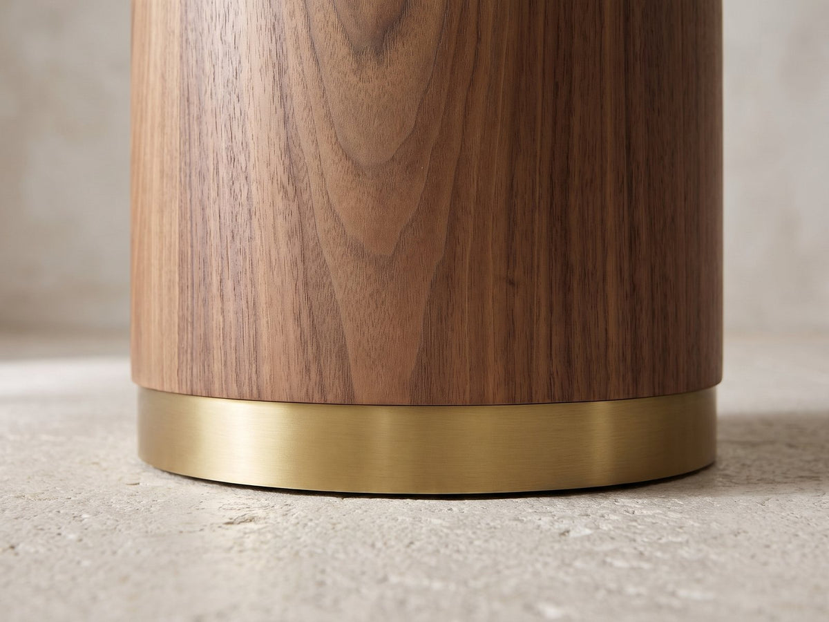 Close-up of the Pietrapertosa Walnut Pedestal Side Table: the brushed brass band at the foot of the walnut pedestal