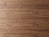 Close-up of the Pietrapertosa Walnut Pedestal Side Table: the walnut grain of the pebble-shaped top
