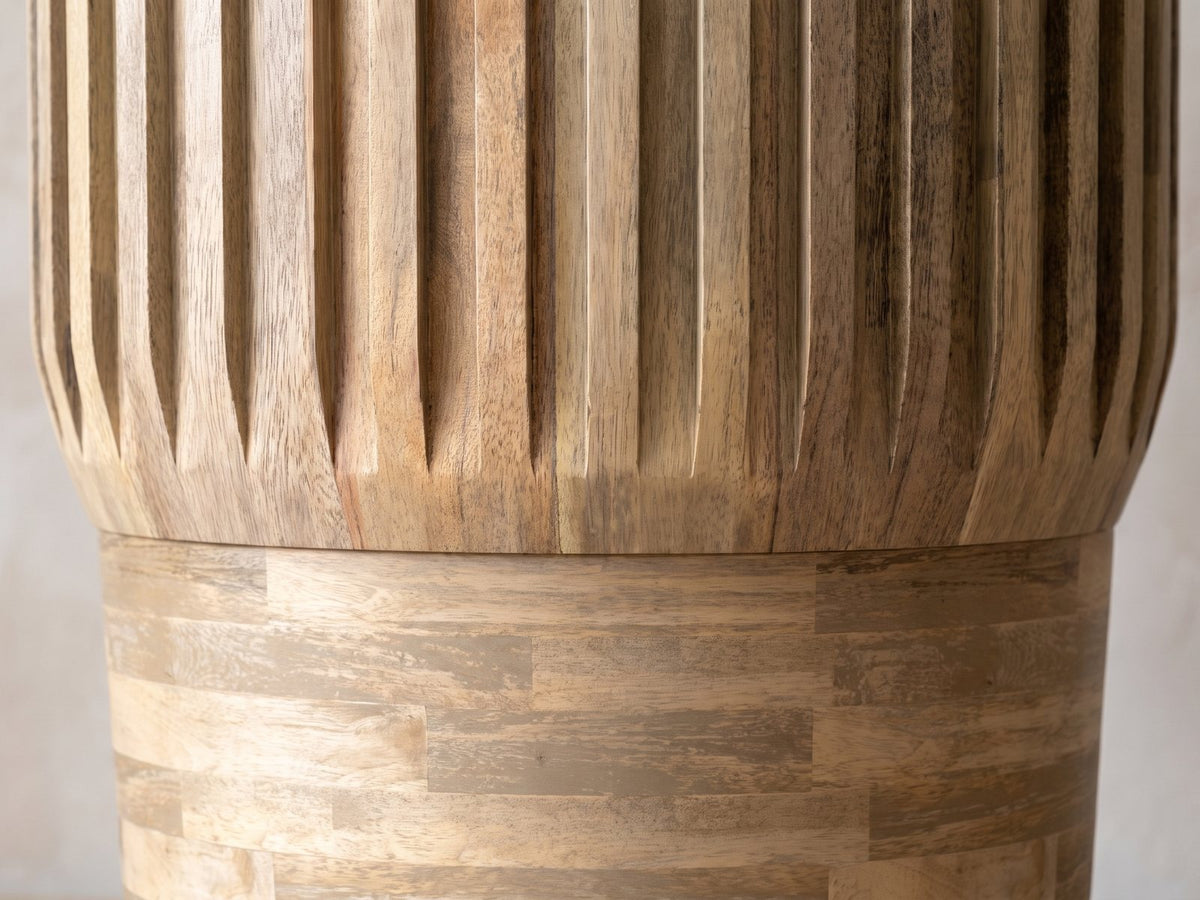 Close-up of the Pievepelago Natural Mango Fluted Drum Side Table: the flat ribs tapering to points above the stacked mango base