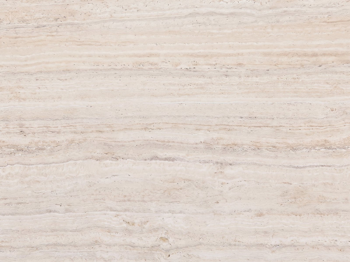 Close-up of the Piombino Faux Travertine Fiberglass Drum Coffee Table: the vein-cut travertine look of the top