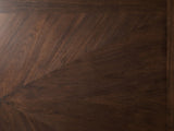 Close-up of the Pizzo 76-Inch Walnut Veneer Extending Trestle Dining Set with Bench and 4 Chairs: the fan-matched walnut veneer of the top inside its cross-banded border
