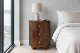 Ploaghe chestnut mango oval nightstand against a pale grey microcement wall in a Seattle waterfront bedroom with a tall window