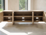 Close-up of the Polignano Oak and Cane Media Console: the four doors open showing the adjustable shelves and cable openings inside