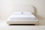 Pollutri bed in cream boucle with a white mattress and pillows (not included), front view