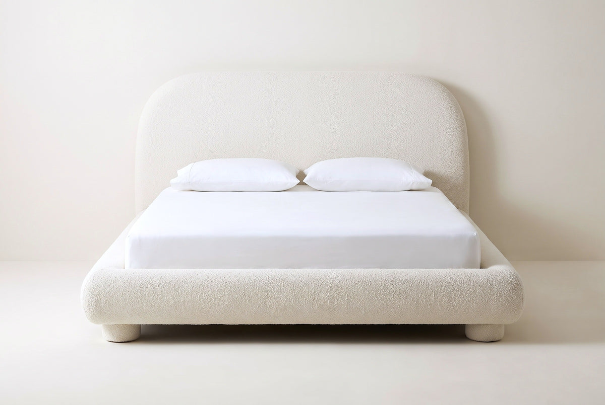 Pollutri bed in cream boucle with a white mattress and pillows (not included), front view