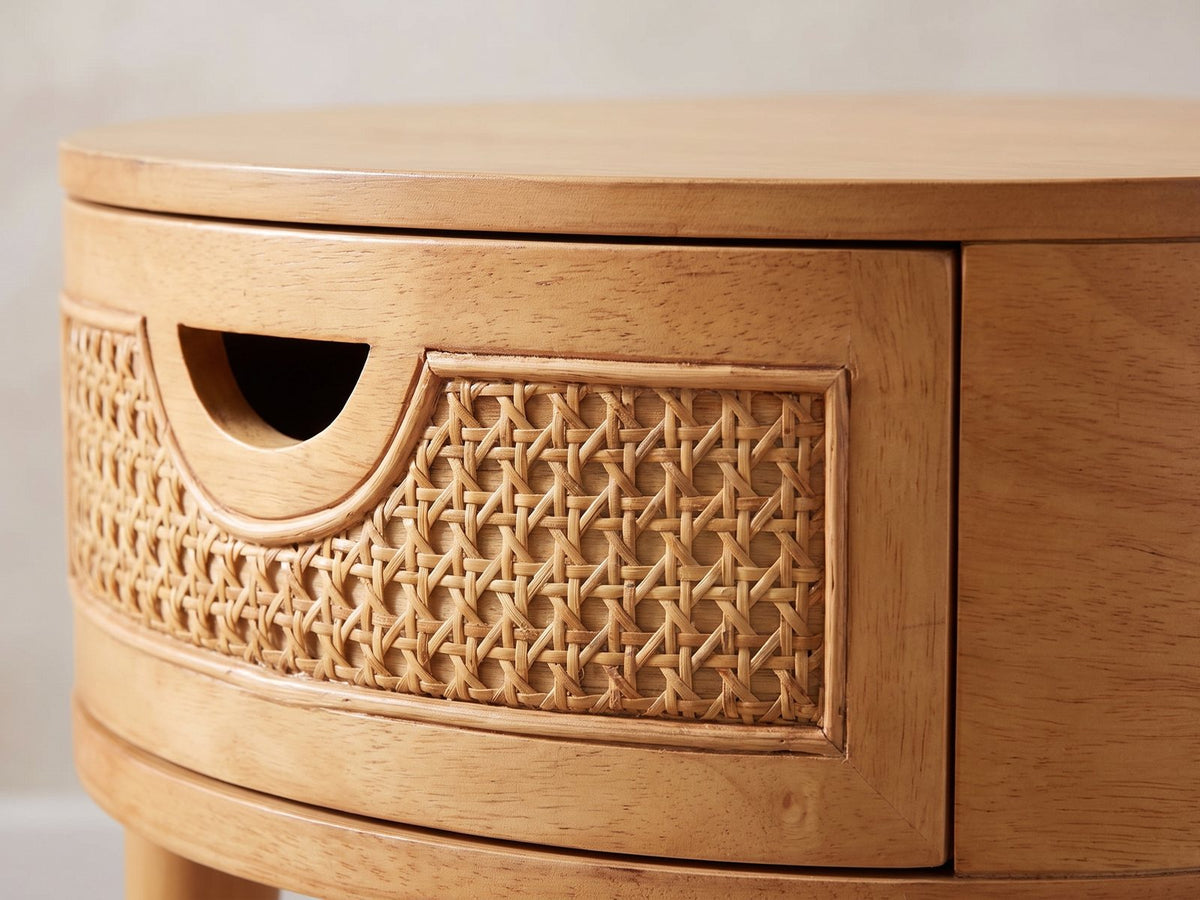 Close-up of the Pontedera Cane and Wood Round Side Table: the cane drawer front with its half-moon pull