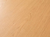 Close-up of the Pontedera Cane and Wood Round Side Table: the oak-tone wood grain of the round top