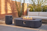 Portopalo fire pit lit on a desert terrace near Tucson, Arizona at golden hour, a rust rammed-earth wall, ocotillo and palo verde behind (sofa not included)