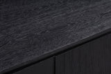 Close-up of the black wire-brushed oak on the Posada nightstand: wavy charcoal-grey grain on a deep matte black top