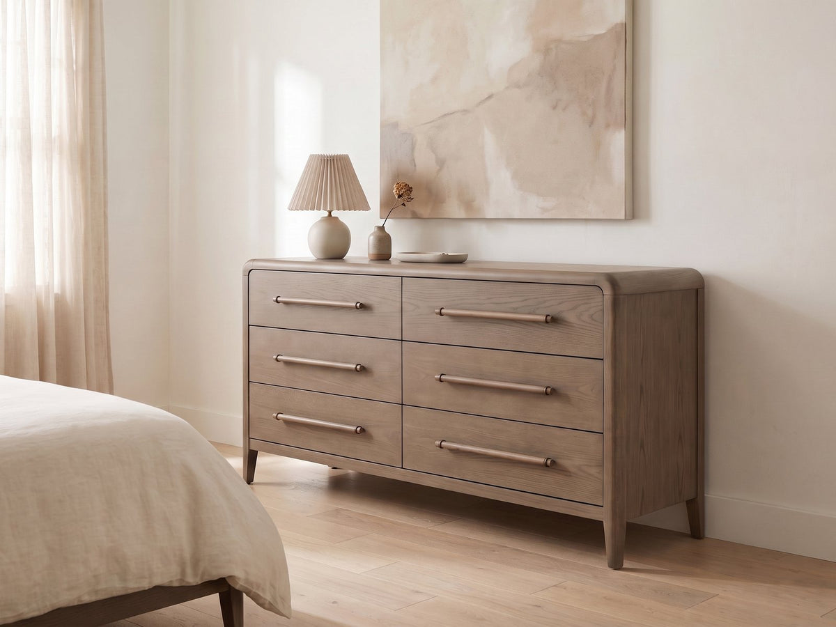 Possagno 54-Inch Latte Elm 6-Drawer Dresser against a plaster wall under an abstract canvas in a bright bedroom