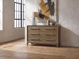 Possagno 54-Inch Latte Elm 6-Drawer Dresser against a plaster wall in an industrial loft bedroom