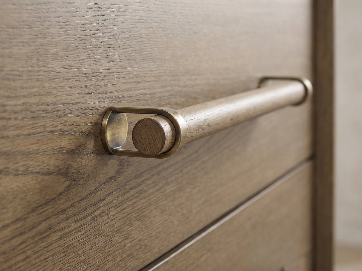 Close-up of the Possagno 54-Inch Latte Elm 6-Drawer Dresser: the wooden dowel pull held in antique-brass loops on the latte elm drawer front