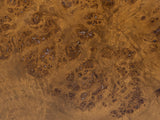 Close-up of the Potenza Walnut Burl Pillar Side Table: the walnut burl veneer of the round top