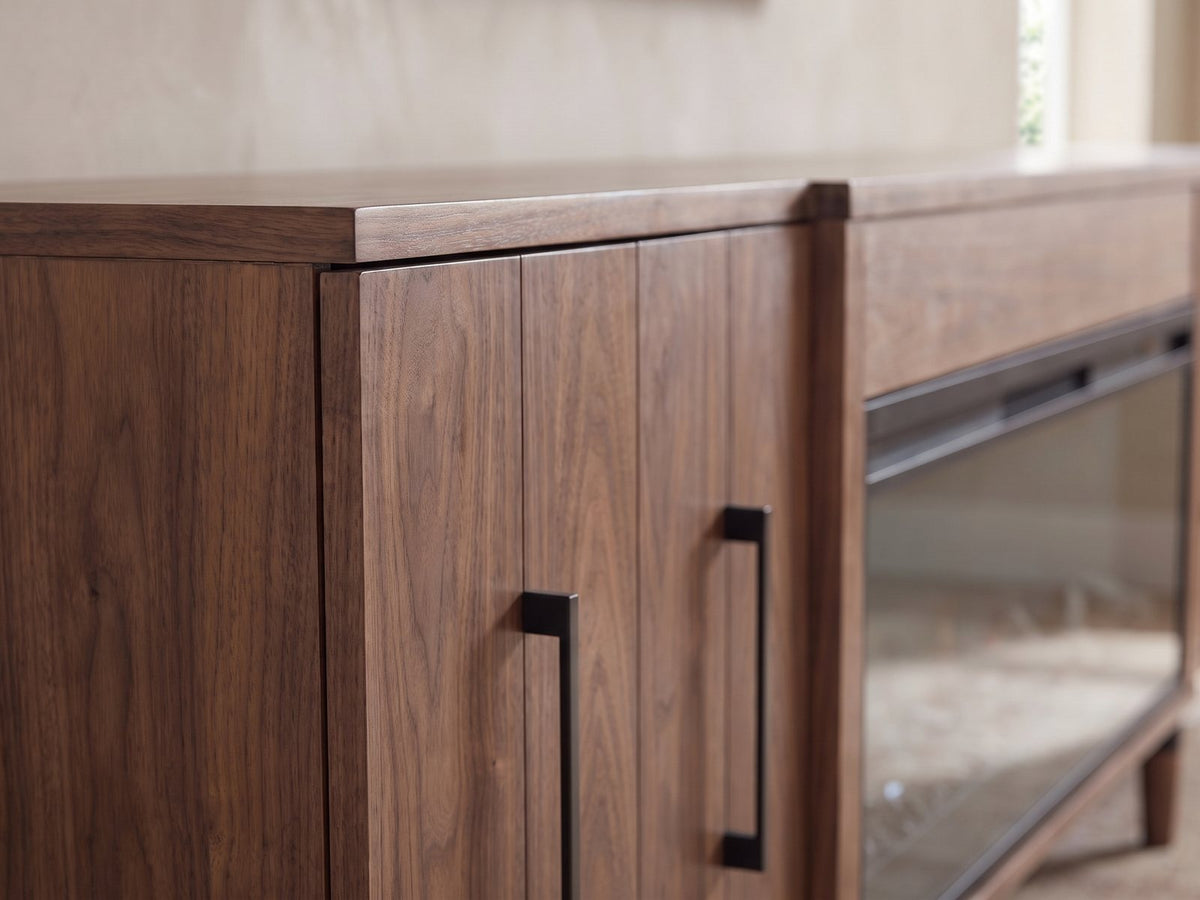 Close-up of the Praiano Walnut Fireplace Media Console: the slatted walnut door and its slim black bar pull