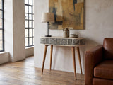 Pulsano Bone Inlay Oval Console Table against a plaster wall in an industrial loft