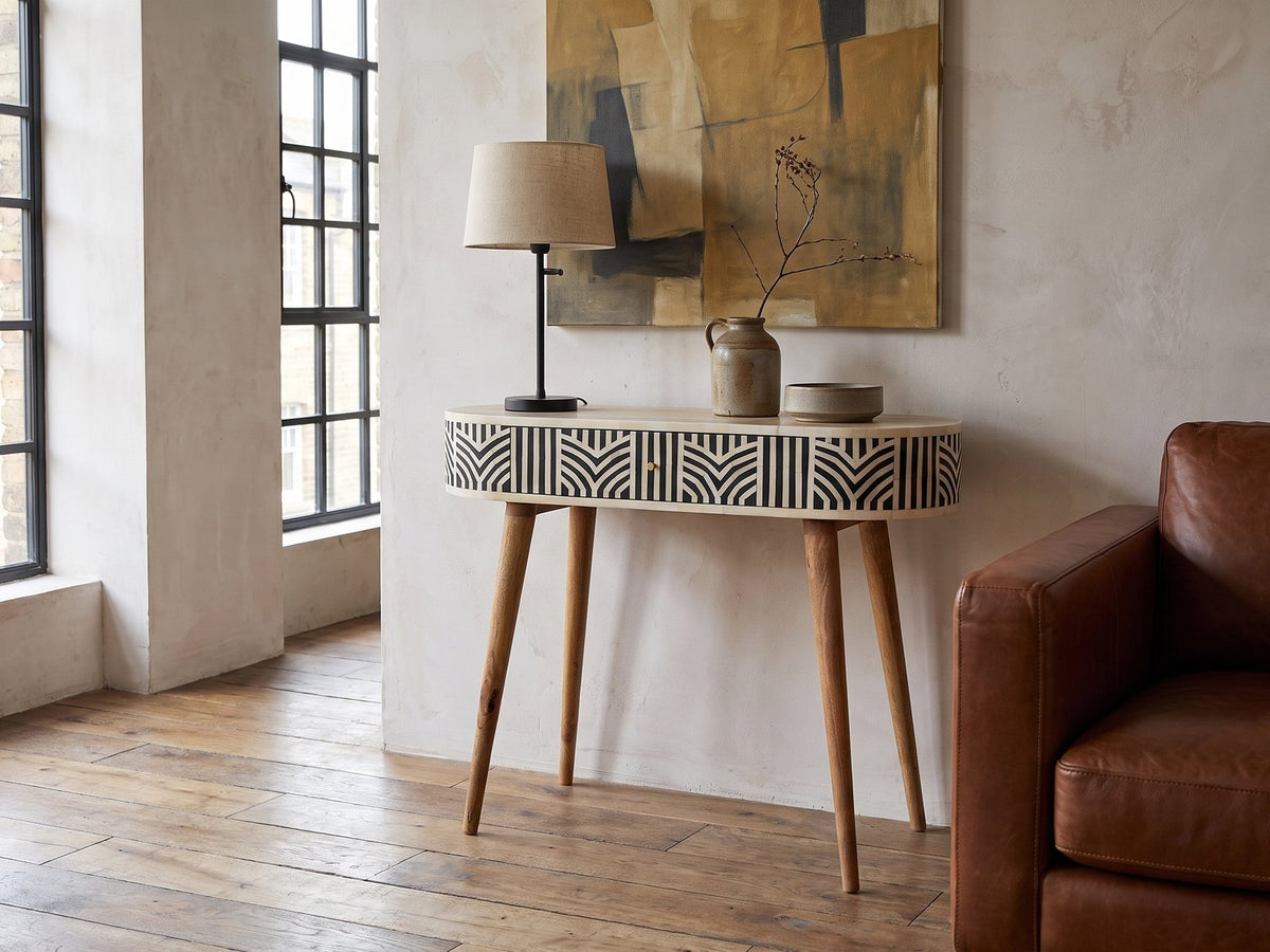 Pulsano Bone Inlay Oval Console Table against a plaster wall in an industrial loft