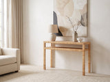 Putignano Wrapped Rattan Two-Tier Console Table against a plaster wall under an abstract canvas in a bright living room