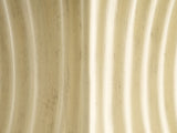 Close-up of the Racale Cream Fiberglass Pleated Side Table: the aged cream milk-paint finish over the pleats