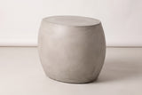 The Racalmuto light grey concrete oval barrel side table, three-quarter view on a light studio backdrop