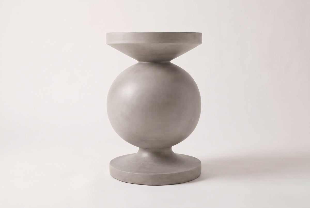 The Raffadali side table seen straight from the side: a round top disc over a concave cone, a full sphere, a slim neck and a round foot disc