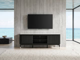 Ragusa Stone Top Media Console under a wall-mounted screen in an oceanfront glass house