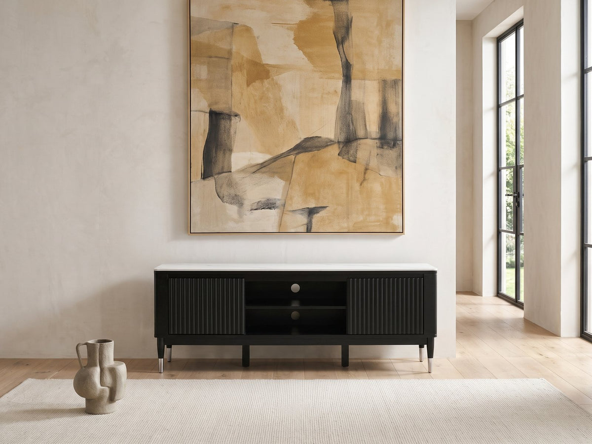 Ragusa Stone Top Media Console under a large abstract painting in a bright living room
