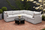 Randazzo light grey L-shaped sectional on a herringbone brick terrace in Atlanta, Georgia, against a black-painted brick wall with creeping fig (coffee table not included)