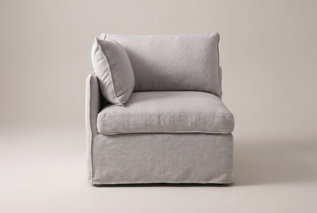 One Randazzo end seat from the front: a slim arm on the left, a back pillow, an angled arm pillow and a thick seat cushion in light grey