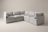 The Randazzo five-seat L-shaped sectional in light grey slipcovers, three-quarter view on a light studio backdrop