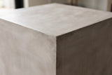 Close-up of the smooth light grey MGO lightweight concrete on a top corner of the Realmonte side table