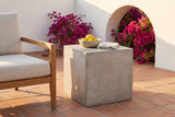 Realmonte concrete cube side table with a bowl of lemons on a terracotta tile terrace in Santa Barbara at golden hour, a white plaster arch and bougainvillea behind (chair and decor not included)