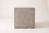 The Realmonte cube side table seen straight from the front: one plain square light grey face