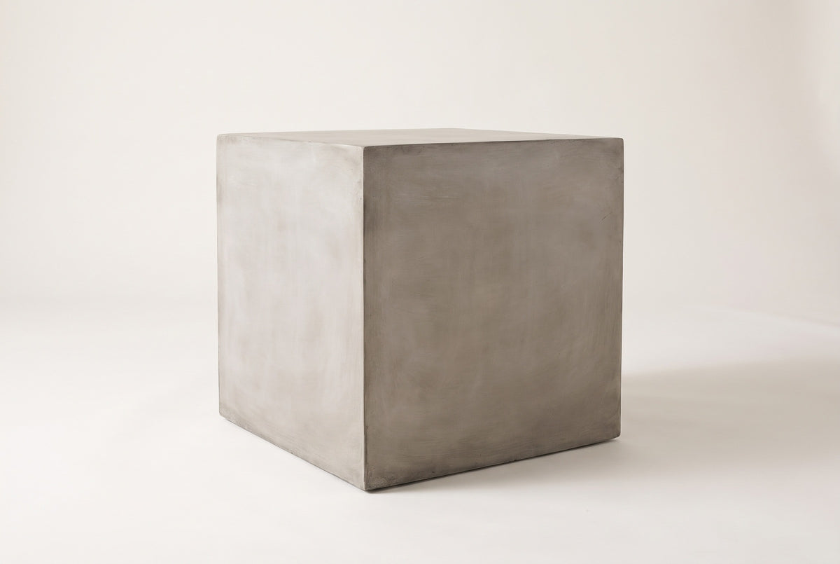The Realmonte light grey concrete cube side table, three-quarter view on a light studio backdrop