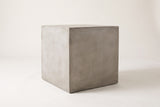The Realmonte light grey concrete cube side table, three-quarter view on a light studio backdrop