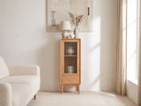 Recco Solid Oak Reeded Glass Storage Cabinet against a plaster wall in a bright living room
