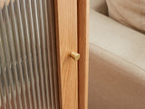 Close-up of the Recco Solid Oak Reeded Glass Storage Cabinet: the brushed-brass door knob beside the reeded glass door