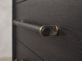 Close-up of the Recoaro 54-Inch Peppercorn Black 6-Drawer Dresser: the wooden dowel pull held in antique-brass loops on the black peppercorn elm drawer front