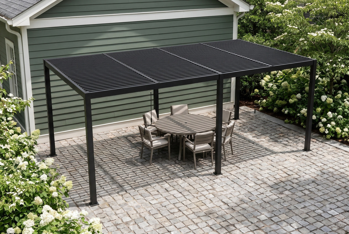 Regalbuto black louvered pergola over a round dining table on granite setts beside a sage-green house in Atlanta, hydrangeas and dogwoods around (furniture not included)