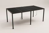The Regalbuto louvered pergola in black aluminum seen from above one corner: four roof panels of louvers on six square posts, two cranks hanging below